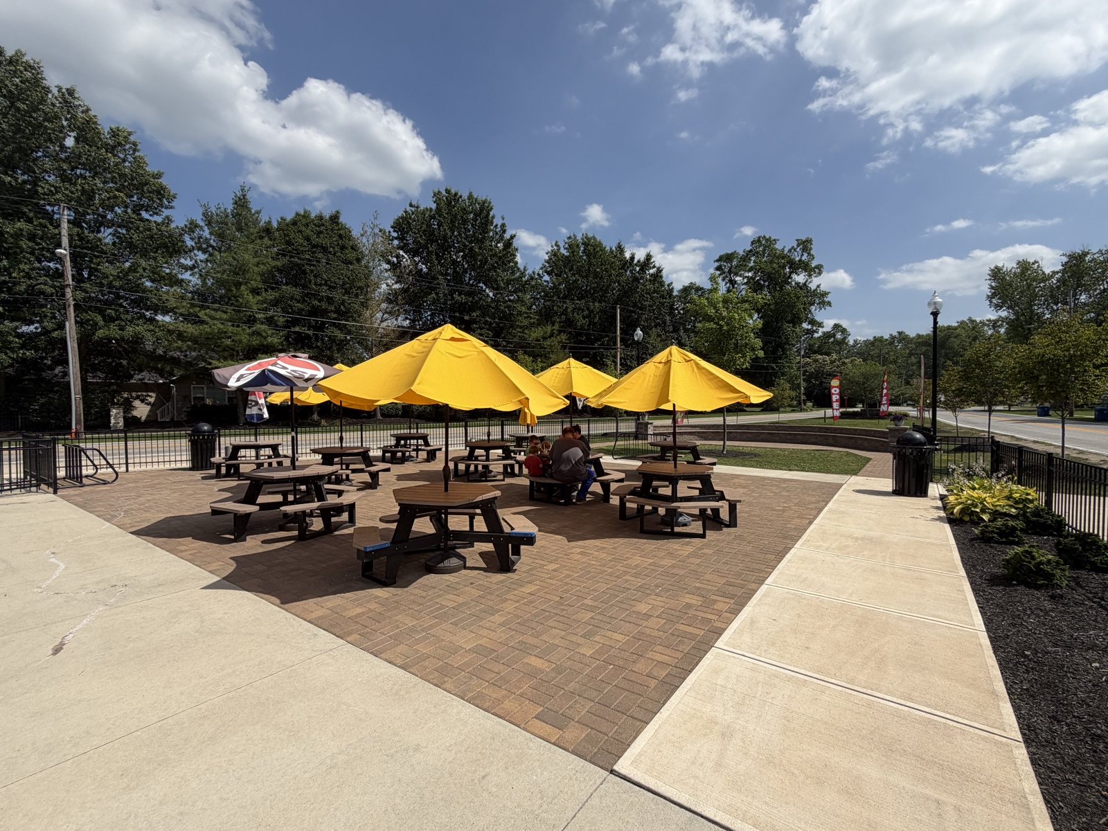 Outdoor patio with picnic tables and yellow umbrellas