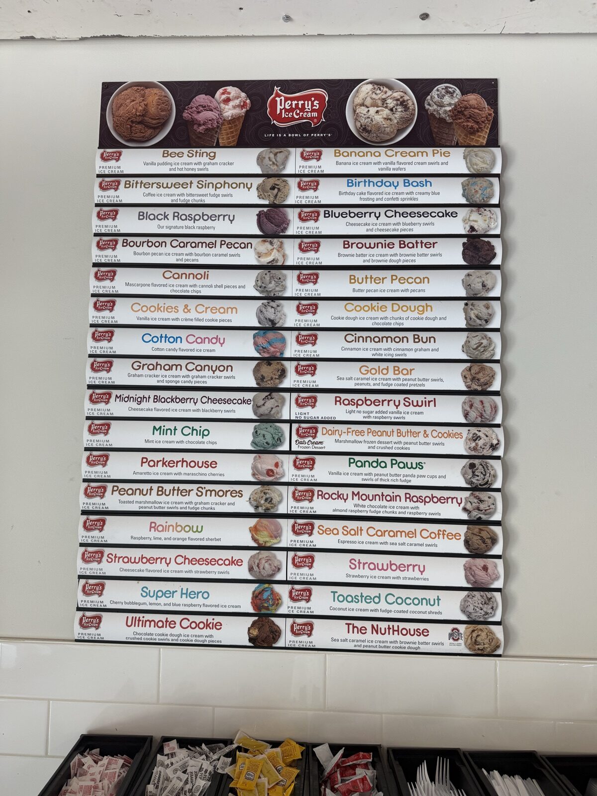 Wall of 33 Perry's Ice Cream flavor cards at Zapps